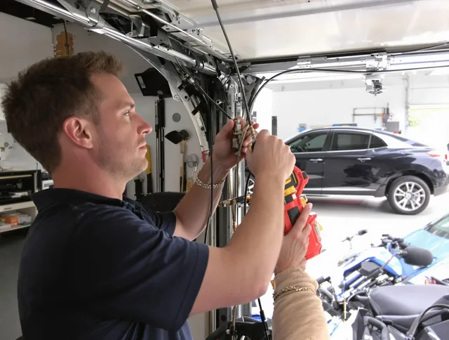 Fountain Garage Door Repair safety certified technician performing cable replacement in Fountain